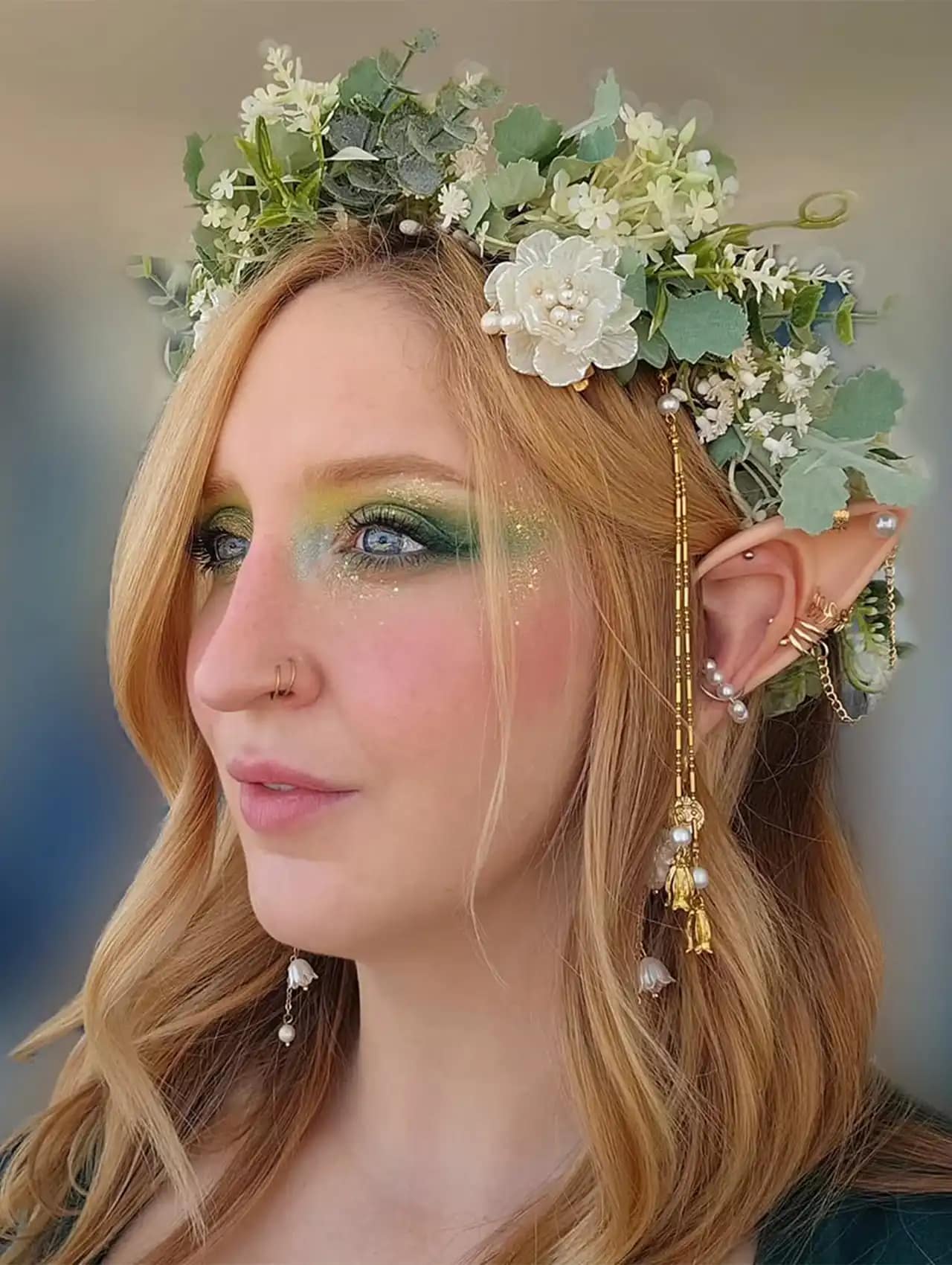 Enchanted halloween makeup looks with elf ears, green glitter eyeshadow, and floral crown.