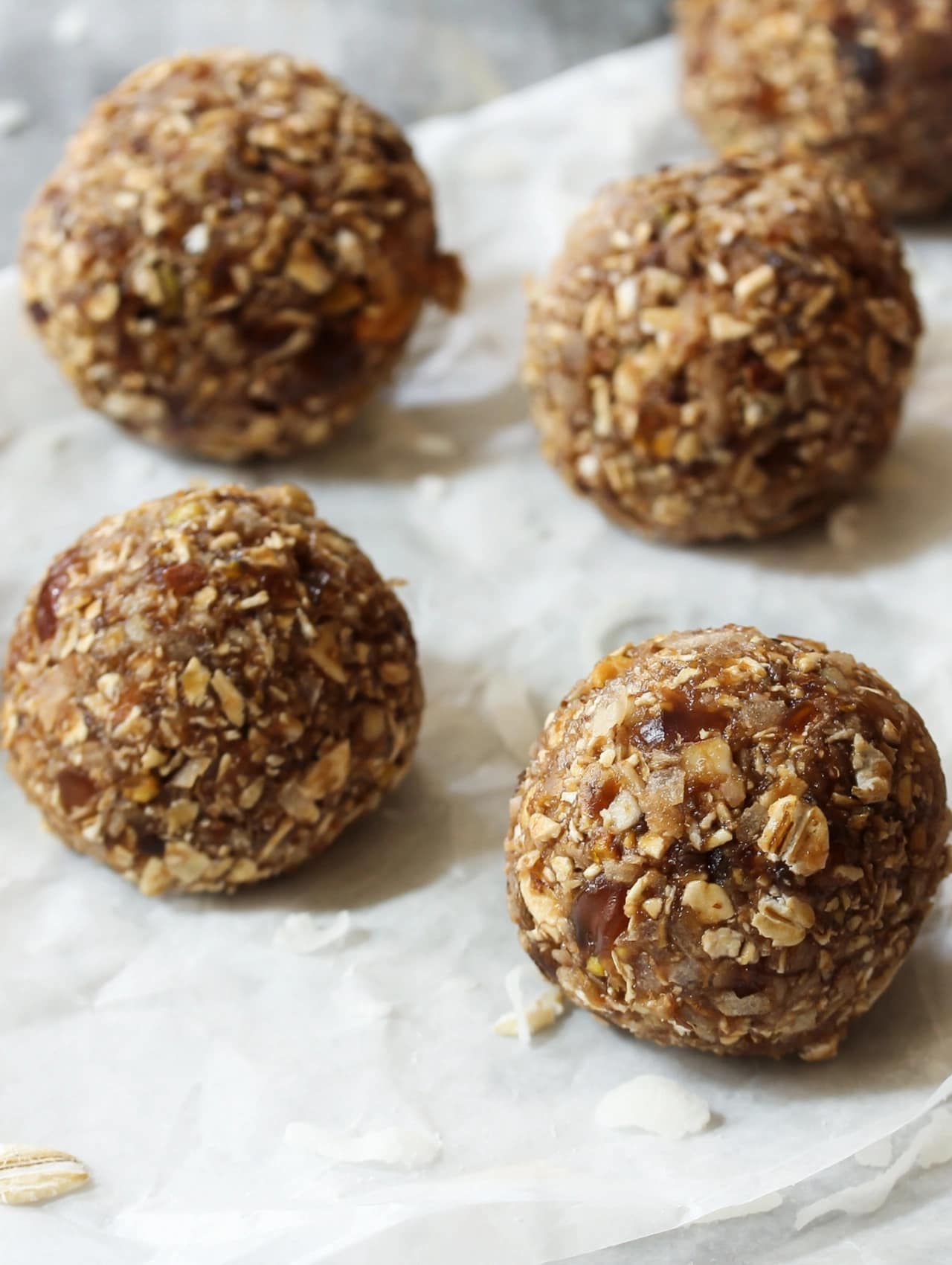 Homemade energy balls displayed on parchment paper, healthy nutrition for gym essentials for beginners.