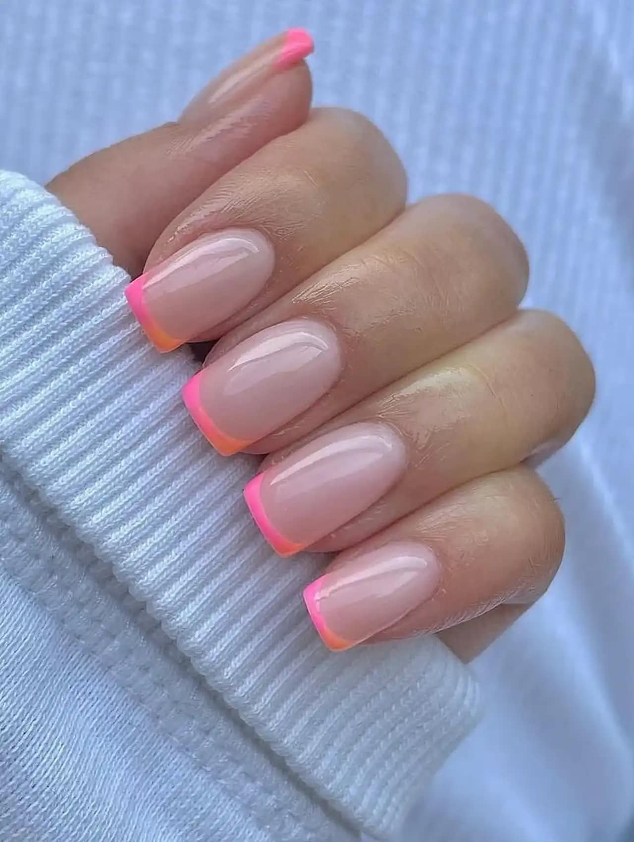Short square nails with ombré pink and orange French tips, nail art design 2025.