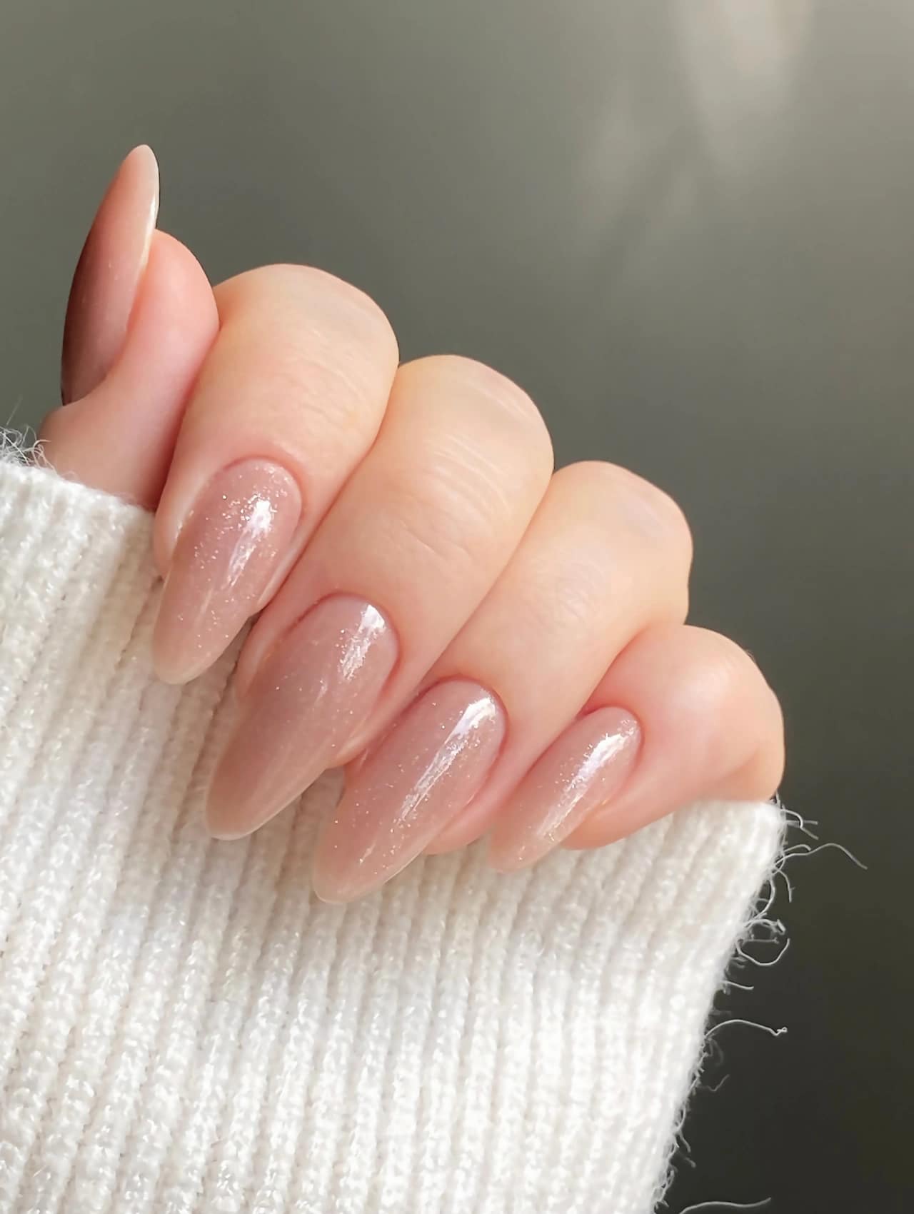 Sheer Winter Glow January Nails with translucent nude polish and subtle shimmer.