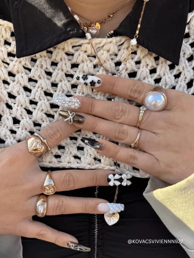 Mixed medium long nails with pearls, metallics, florals, and charms.